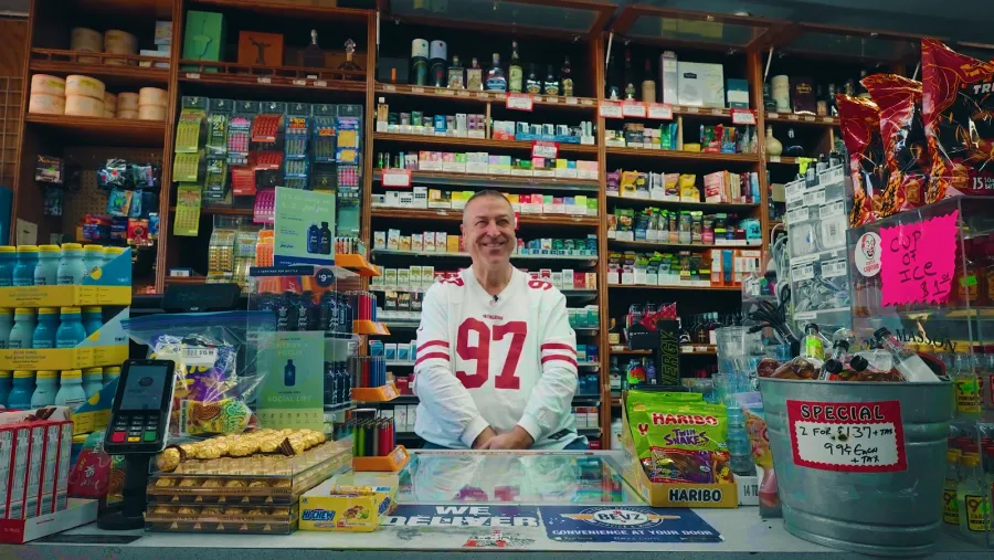 The owner of Circus Liquor behind the counter